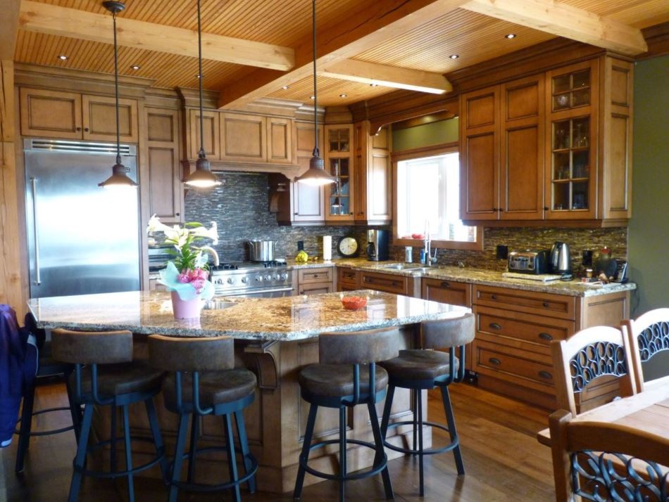 Rustic l-shaped enclosed kitchen in Toronto with a double-bowl sink, recessed-panel cabinets, medium wood cabinets, granite worktops, multi-coloured splashback, matchstick tiled splashback, stainless steel appliances, medium hardwood flooring and an island.