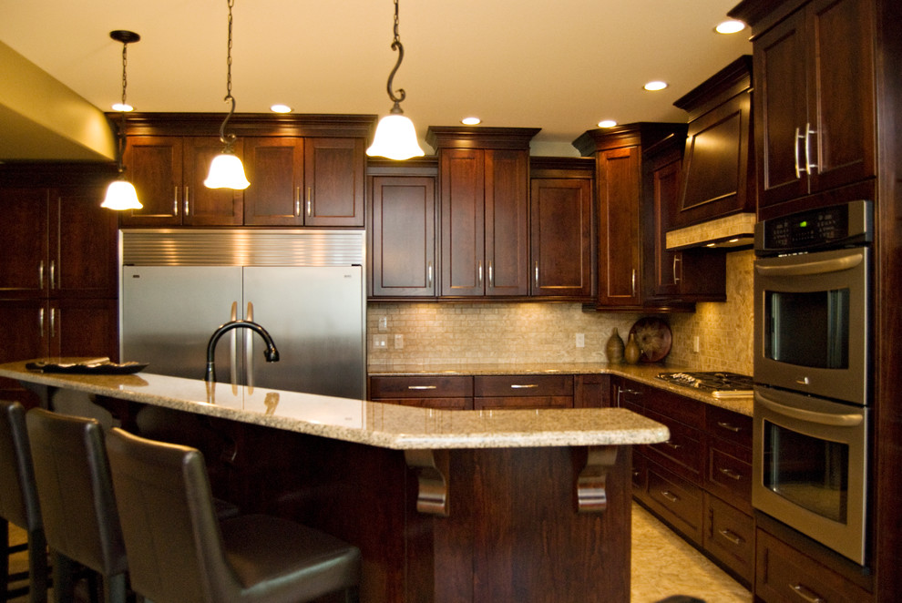 Example of a small classic l-shaped eat-in kitchen design in Vancouver with an undermount sink, shaker cabinets, dark wood cabinets, granite countertops and beige backsplash