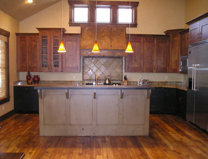 Example of a mid-sized medium tone wood floor kitchen design in Salt Lake City with medium tone wood cabinets, beige backsplash and an island