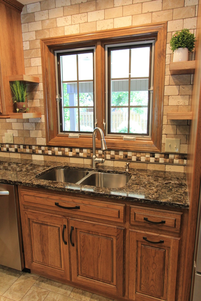 Example of a large classic ceramic tile kitchen design in Other with an undermount sink, raised-panel cabinets, medium tone wood cabinets, quartz countertops, multicolored backsplash, mosaic tile backsplash, stainless steel appliances and an island