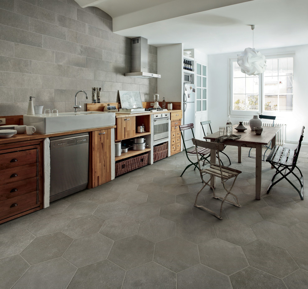 Example of a mid-sized transitional single-wall porcelain tile eat-in kitchen design in Denver with a farmhouse sink, flat-panel cabinets, medium tone wood cabinets, wood countertops, gray backsplash, porcelain backsplash and stainless steel appliances