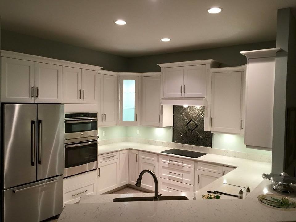 Design ideas for a classic u-shaped open plan kitchen in Miami with shaker cabinets, white cabinets, stainless steel appliances, no island and limestone worktops.