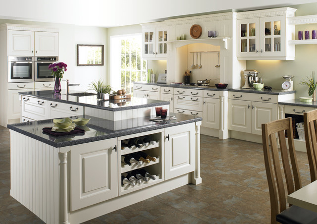 Example of a large arts and crafts l-shaped brown floor eat-in kitchen design in Miami with an undermount sink, raised-panel cabinets, white cabinets, stainless steel appliances and an island