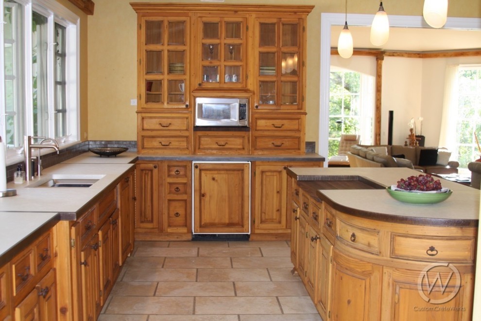 Inspiration for a large timeless l-shaped ceramic tile eat-in kitchen remodel in Milwaukee with an undermount sink, raised-panel cabinets, medium tone wood cabinets, concrete countertops and an island