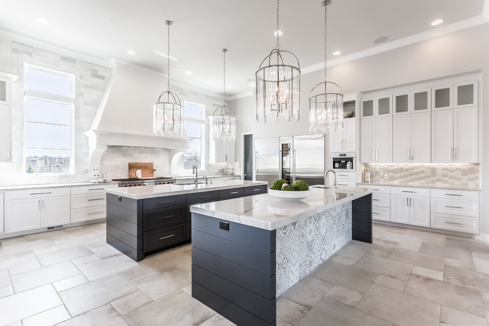 Transitional l-shaped beige floor kitchen photo in Kansas City with an undermount sink, shaker cabinets, white cabinets, gray backsplash, stainless steel appliances, two islands and white countertops