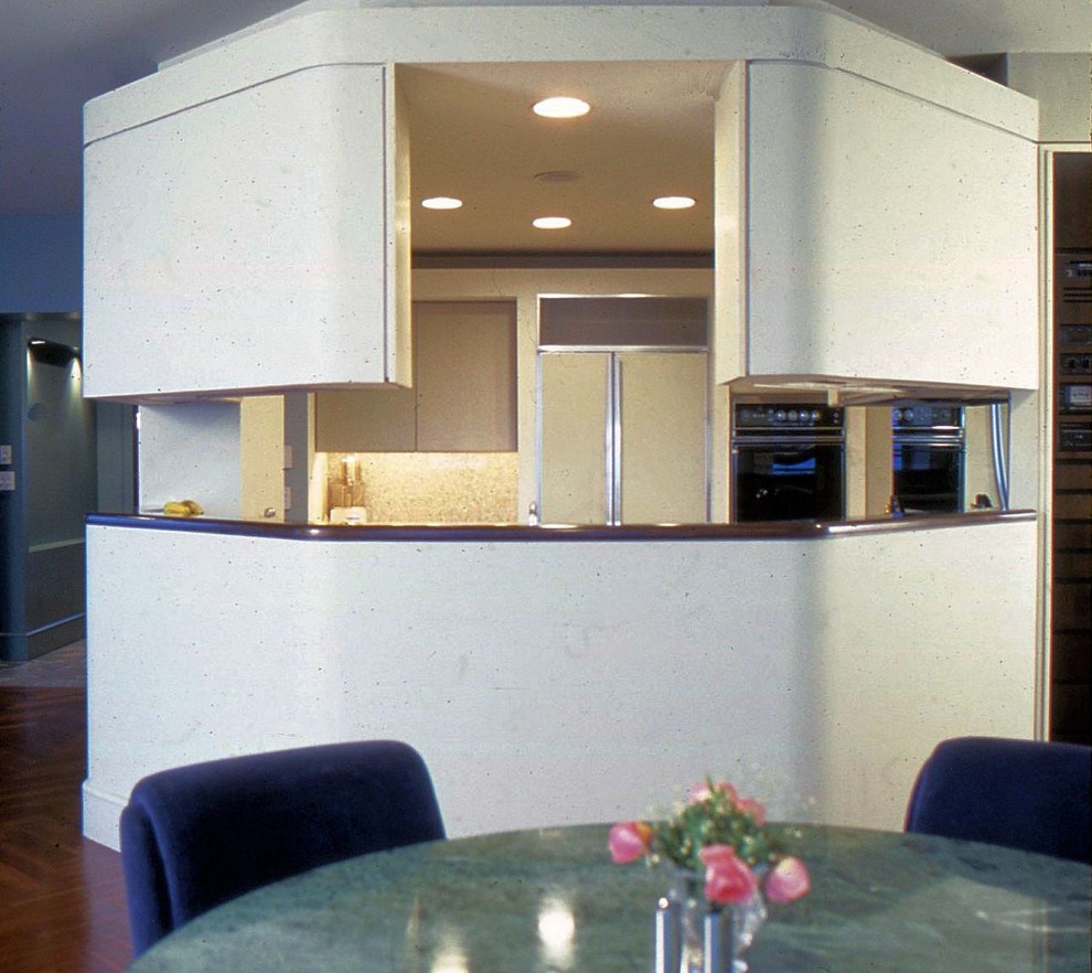 Inspiration for an expansive modern u-shaped kitchen/diner in New York with a built-in sink, flat-panel cabinets, beige cabinets, granite worktops, multi-coloured splashback, stone slab splashback, integrated appliances and medium hardwood flooring.