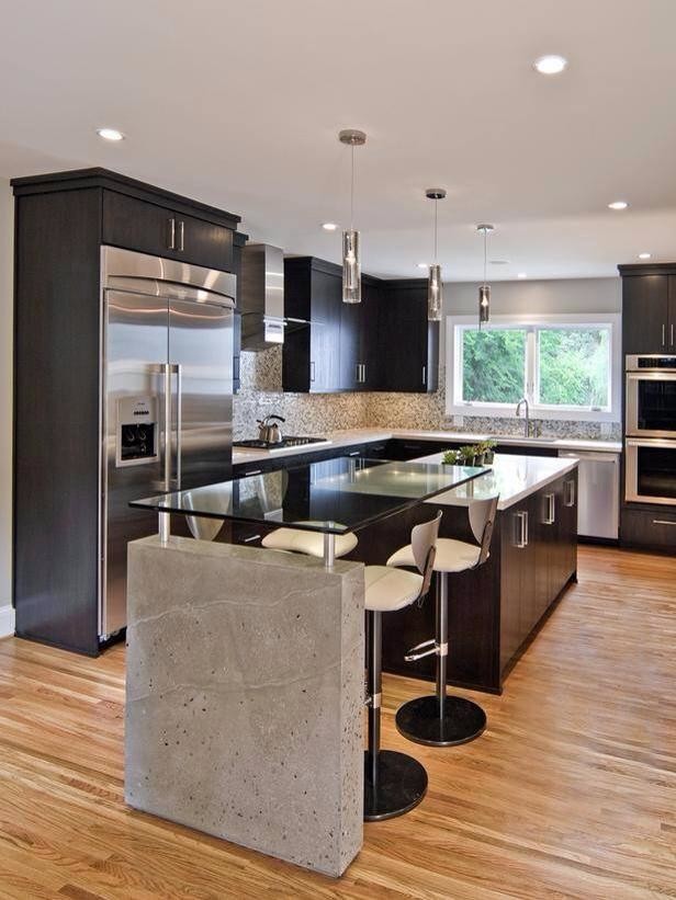 This is an example of a large contemporary l-shaped kitchen in Orange County with a submerged sink, flat-panel cabinets, black cabinets, composite countertops, multi-coloured splashback, mosaic tiled splashback, stainless steel appliances, medium hardwood flooring, an island and brown floors.