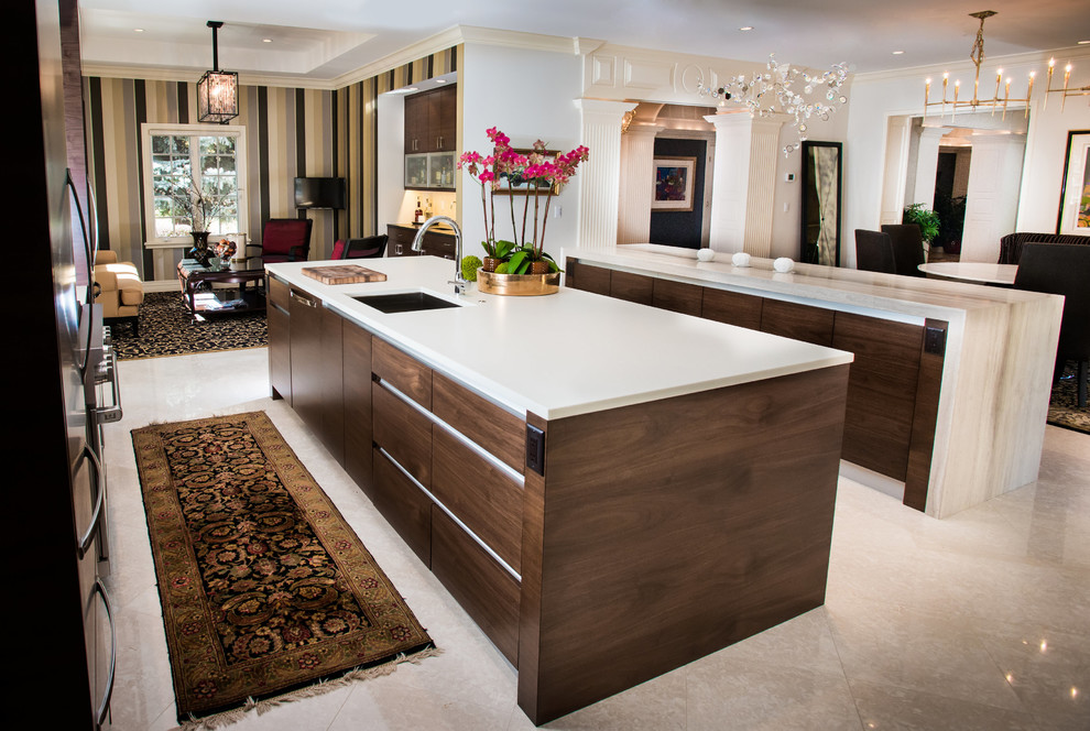 Large contemporary u-shaped open plan kitchen in Denver with a submerged sink, flat-panel cabinets, dark wood cabinets, engineered stone countertops, beige splashback, porcelain splashback, integrated appliances, limestone flooring and multiple islands.