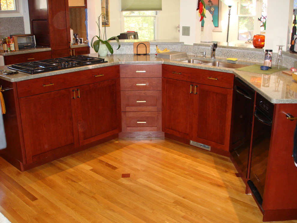 Example of a mid-sized classic u-shaped light wood floor eat-in kitchen design in DC Metro with a double-bowl sink, flat-panel cabinets, dark wood cabinets, granite countertops, multicolored backsplash, glass tile backsplash, stainless steel appliances and no island