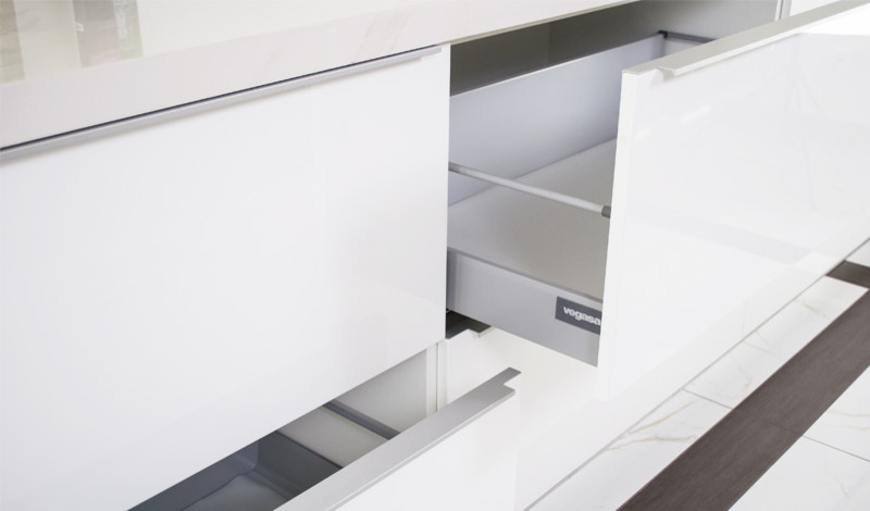 Ejemplo de cocina minimalista de tamaño medio abierta con armarios con paneles lisos, puertas de armario blancas y una isla