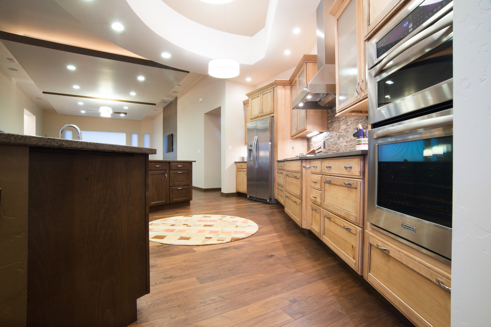 Inspiration for a medium sized contemporary single-wall open plan kitchen in Albuquerque with a submerged sink, glass-front cabinets, light wood cabinets, multi-coloured splashback, stainless steel appliances, an island and dark hardwood flooring.