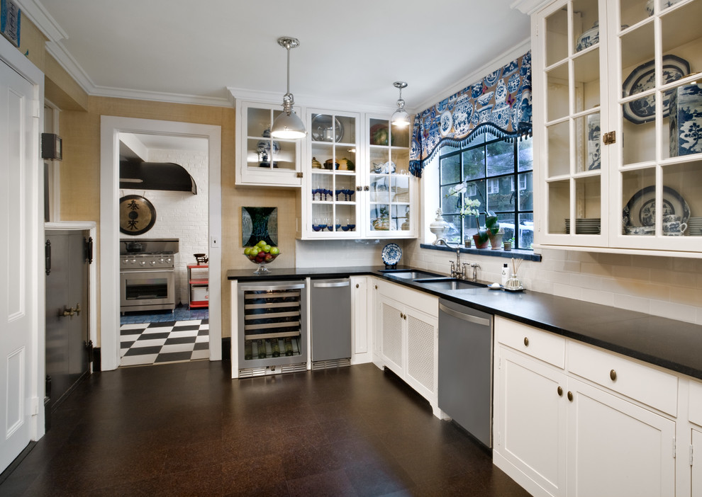 Large elegant kitchen photo in New York with white cabinets, stainless steel appliances and an island