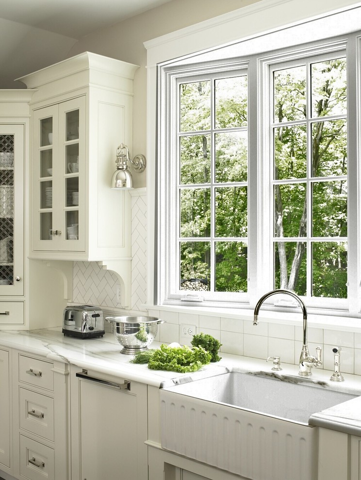 Inspiration for a timeless kitchen remodel in DC Metro with a farmhouse sink, recessed-panel cabinets, white cabinets, white backsplash and subway tile backsplash