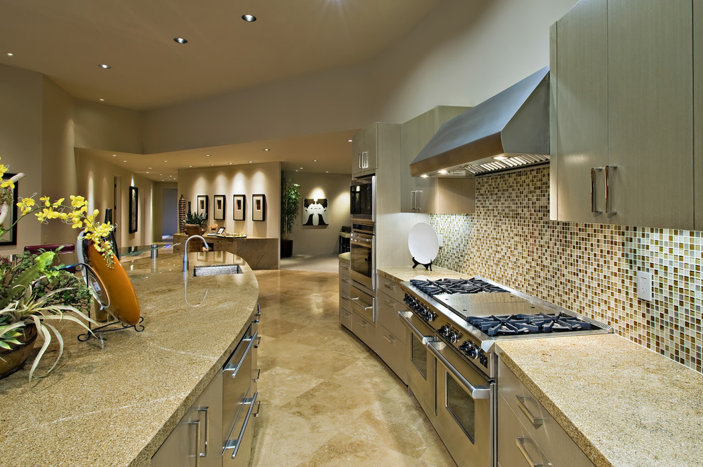 ロサンゼルスにある高級な広いおしゃれなキッチン (ドロップインシンク、レイズドパネル扉のキャビネット、ステンレスキャビネット、御影石カウンター、シルバーの調理設備、大理石の床) の写真