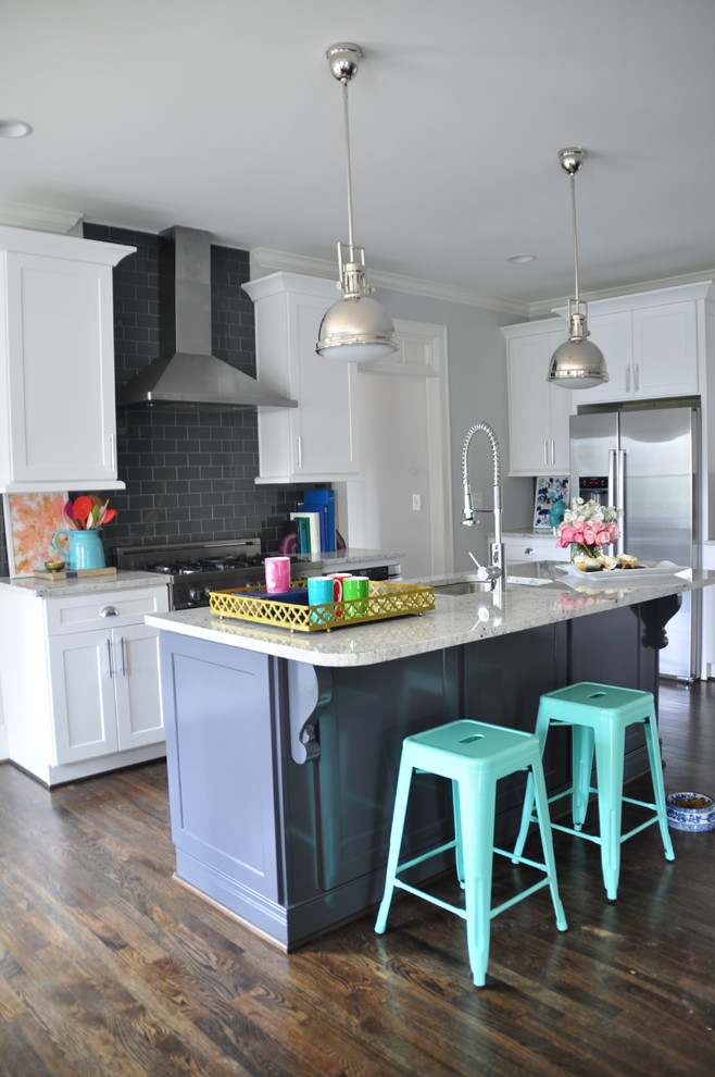 Example of a mid-sized eclectic l-shaped dark wood floor eat-in kitchen design in Atlanta with an undermount sink, recessed-panel cabinets, white cabinets, granite countertops, white backsplash, ceramic backsplash, stainless steel appliances and an island