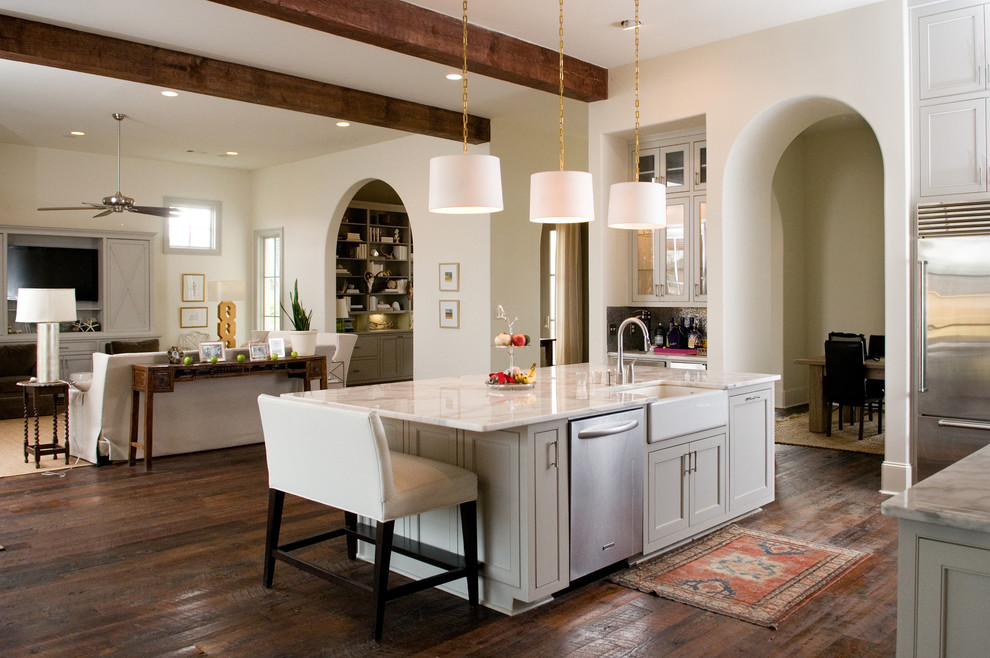 Example of a large eclectic l-shaped dark wood floor open concept kitchen design in New Orleans with a farmhouse sink, shaker cabinets, gray cabinets, marble countertops, metallic backsplash, stainless steel appliances and an island