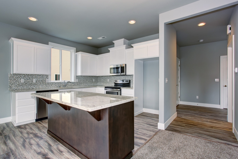 Example of a mid-sized minimalist l-shaped light wood floor open concept kitchen design in Seattle with an undermount sink, shaker cabinets, white cabinets, granite countertops, gray backsplash, stainless steel appliances and an island
