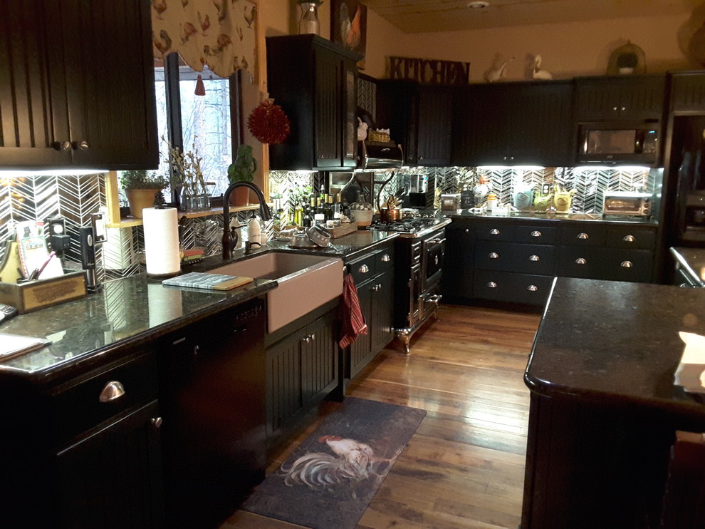 Eat-in kitchen - small victorian l-shaped medium tone wood floor eat-in kitchen idea in Phoenix with recessed-panel cabinets, green cabinets, a farmhouse sink, granite countertops, glass tile backsplash and black appliances