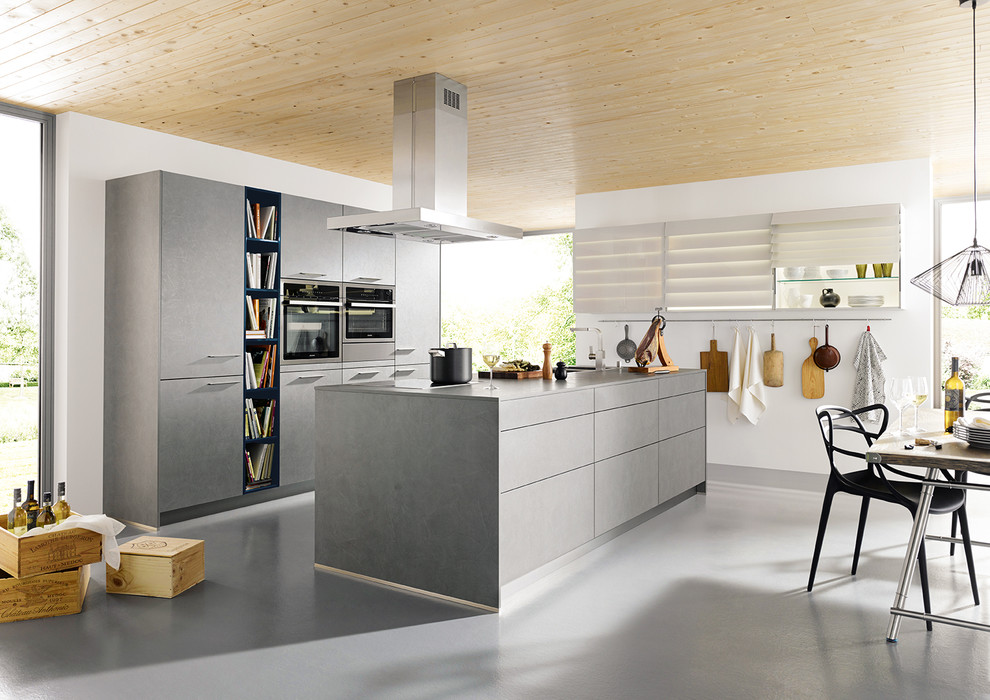 Open concept kitchen - large scandinavian galley open concept kitchen idea in Other with a drop-in sink, flat-panel cabinets, gray cabinets, concrete countertops and an island