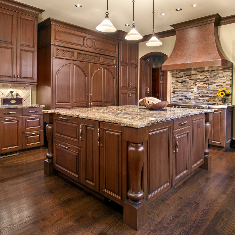 Inspiration for a large traditional kitchen in Nashville with a submerged sink, raised-panel cabinets, dark wood cabinets, granite worktops, integrated appliances, dark hardwood flooring, multiple islands, multi-coloured splashback, brown floors and multicoloured worktops.