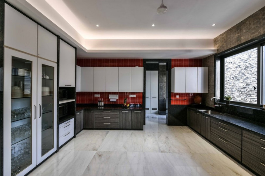 Design ideas for a large modern u-shaped enclosed kitchen in New York with a single-bowl sink, flat-panel cabinets, dark wood cabinets, engineered stone countertops, red splashback, ceramic splashback, black appliances, marble flooring, no island and white floors.