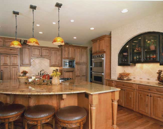 Inspiration for a transitional medium tone wood floor kitchen remodel in Denver with medium tone wood cabinets, granite countertops, beige backsplash and an island