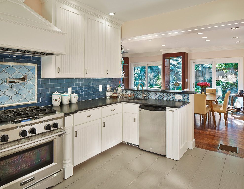 Elegant u-shaped eat-in kitchen photo in Dallas with a farmhouse sink, beaded inset cabinets, white cabinets, granite countertops, blue backsplash, subway tile backsplash and stainless steel appliances