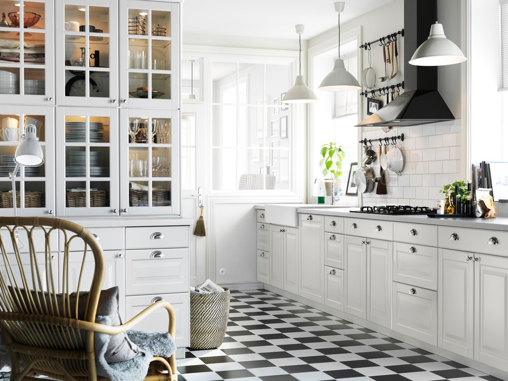 Elegant kitchen photo in Other with a farmhouse sink, raised-panel cabinets, white cabinets, white backsplash and subway tile backsplash