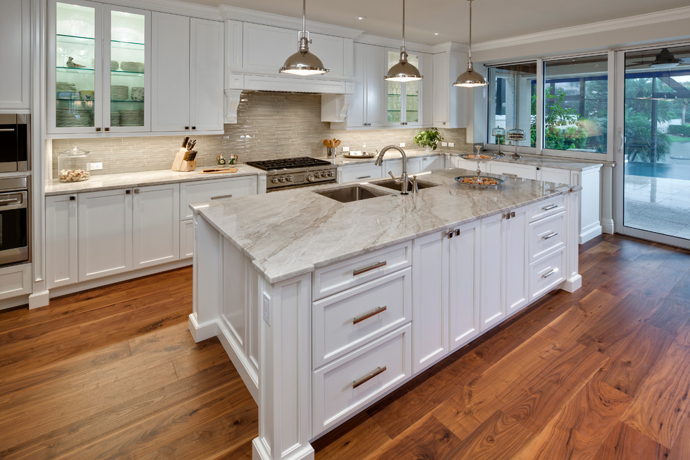Example of a large trendy u-shaped eat-in kitchen design in Miami with granite countertops, gray backsplash, stainless steel appliances and an island