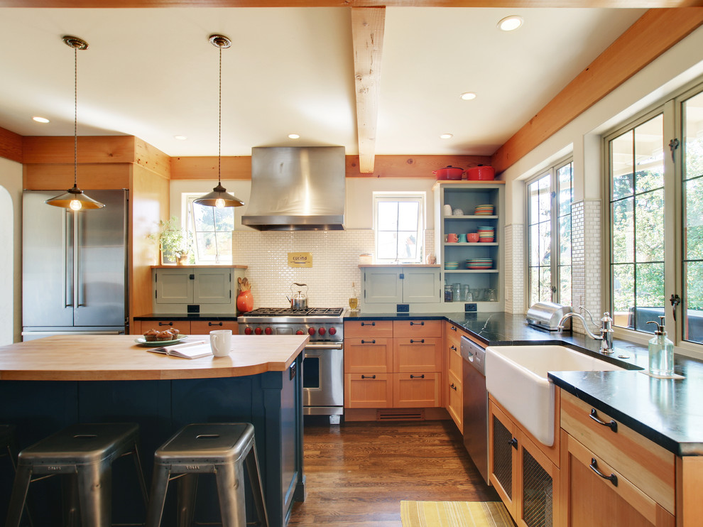 Inspiration for a timeless kitchen remodel in Seattle with a farmhouse sink, soapstone countertops, stainless steel appliances and white backsplash