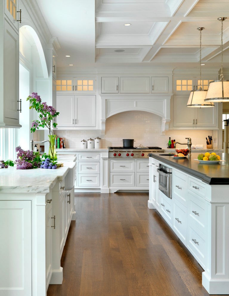 Kitchen - traditional kitchen idea in Boston with a farmhouse sink, marble countertops, white cabinets, beaded inset cabinets, white backsplash and subway tile backsplash