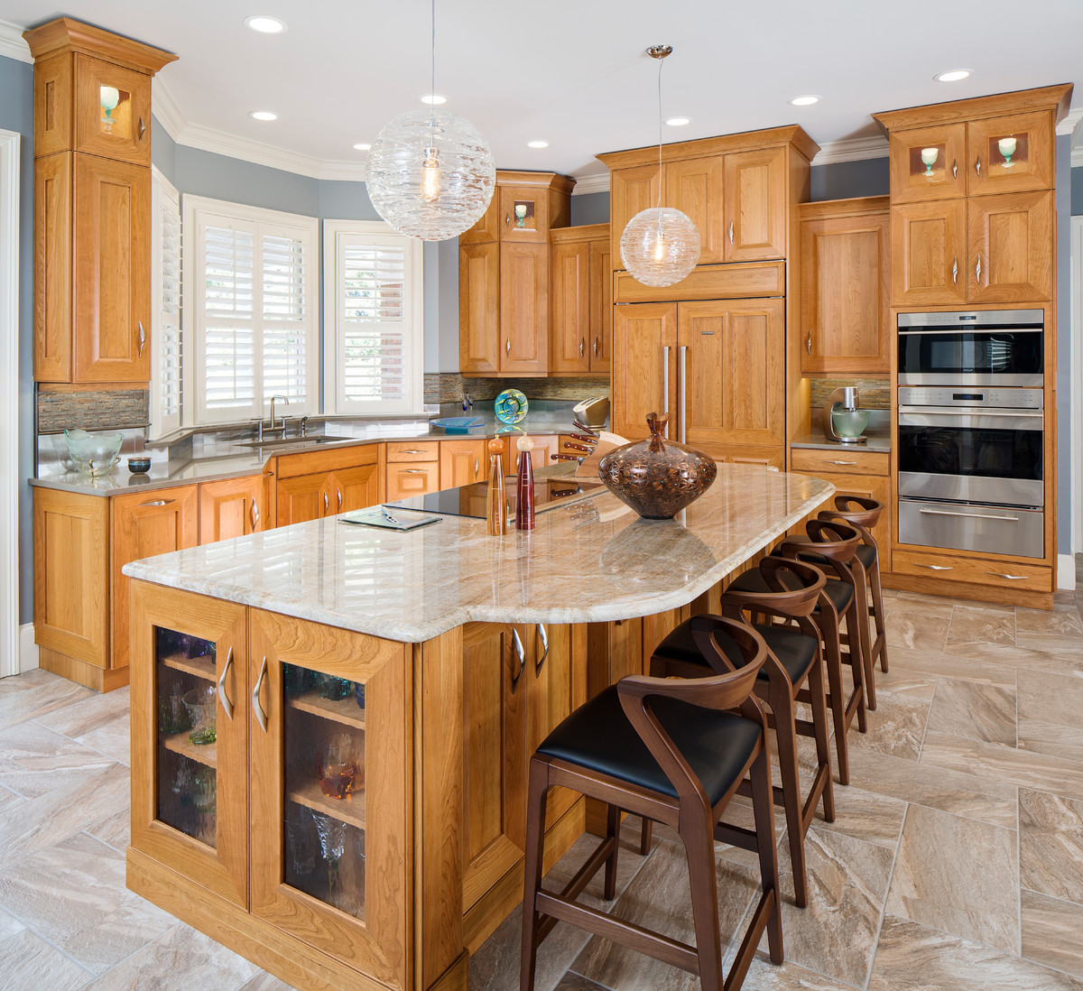 Inspiration for a large transitional l-shaped porcelain tile and brown floor open concept kitchen remodel in Atlanta with an undermount sink, flat-panel cabinets, light wood cabinets, quartzite countertops, brown backsplash, slate backsplash, paneled appliances and an island