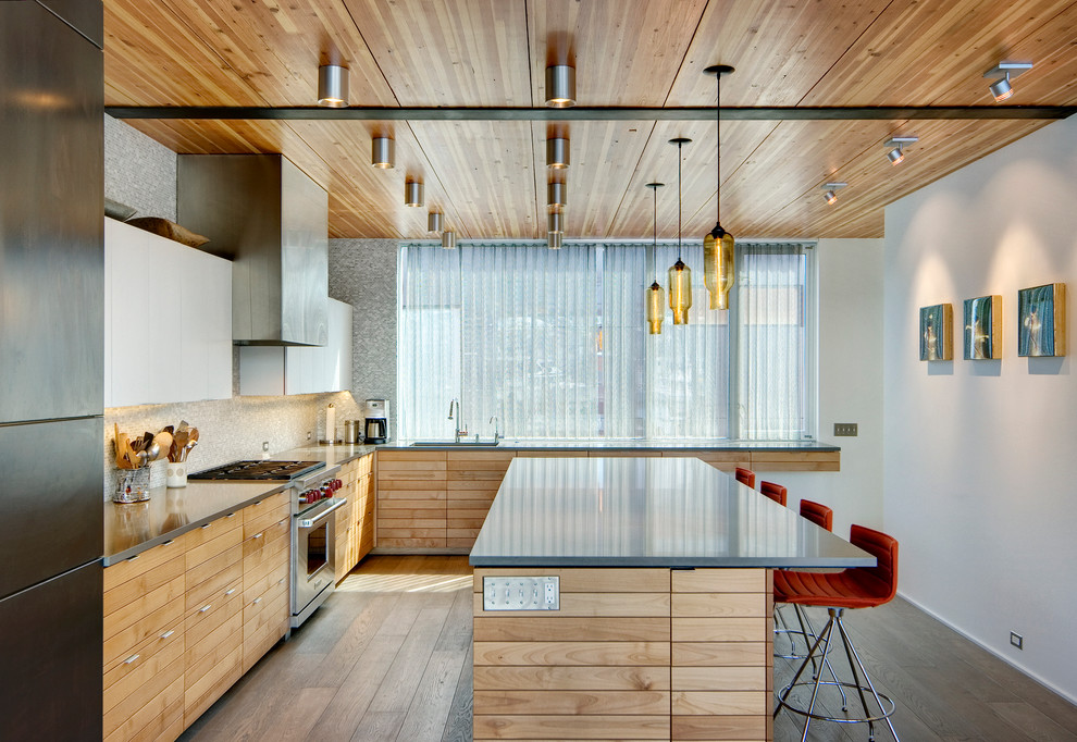 Стильный дизайн: угловая кухня в современном стиле с светлыми деревянными фасадами, разноцветным фартуком, фартуком из плитки мозаики, техникой из нержавеющей стали, паркетным полом среднего тона и островом - последний тренд