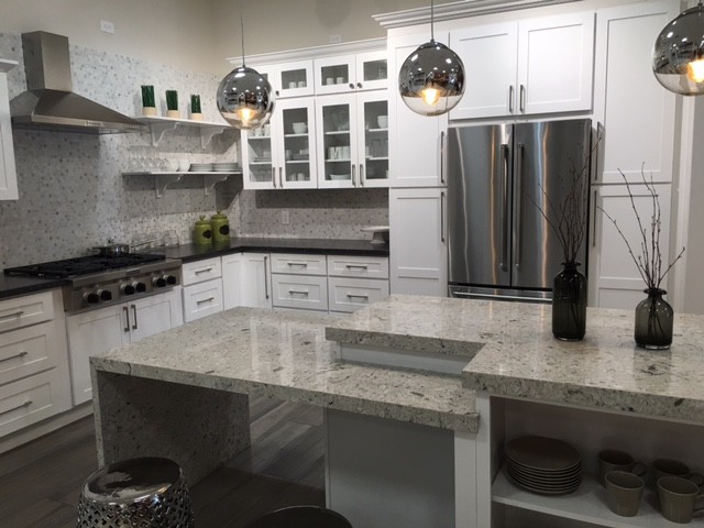 Design ideas for a medium sized traditional l-shaped enclosed kitchen in Orange County with white cabinets, grey splashback, mosaic tiled splashback, stainless steel appliances, dark hardwood flooring, shaker cabinets, granite worktops, an island and grey floors.