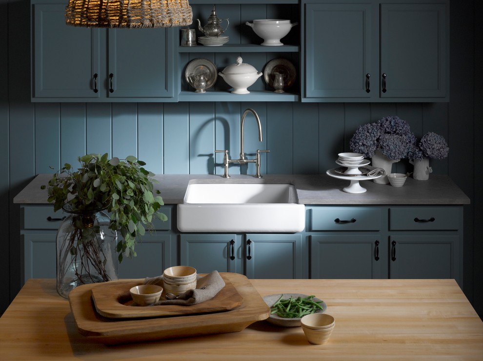 Example of a small classic single-wall enclosed kitchen design in Chicago with a farmhouse sink, recessed-panel cabinets, blue cabinets, concrete countertops, blue backsplash, wood backsplash, paneled appliances and an island
