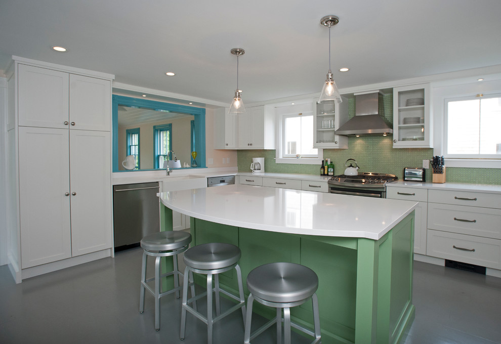 Inspiration for a large contemporary l-shaped gray floor open concept kitchen remodel in Boston with a farmhouse sink, glass-front cabinets, white cabinets, solid surface countertops, green backsplash, glass tile backsplash, stainless steel appliances and an island