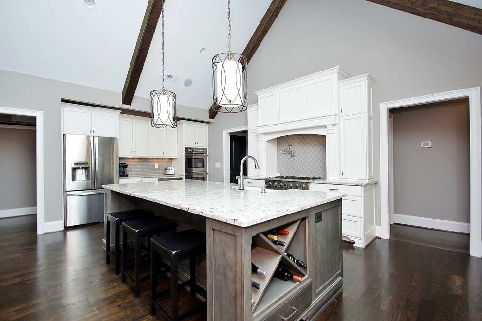 Eat-in kitchen - large craftsman dark wood floor eat-in kitchen idea in Other with a farmhouse sink, shaker cabinets, white cabinets, granite countertops, gray backsplash, subway tile backsplash, stainless steel appliances and an island