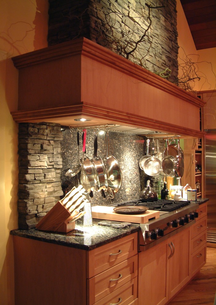 Photo of a classic kitchen in New York with granite worktops, grey splashback, stone tiled splashback, stainless steel appliances and light hardwood flooring.