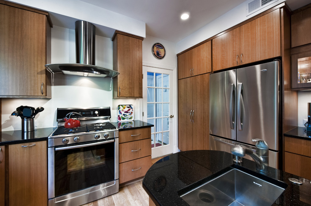 Kitchen - mid-sized contemporary galley medium tone wood floor kitchen idea in DC Metro with flat-panel cabinets, medium tone wood cabinets, stainless steel appliances and an island