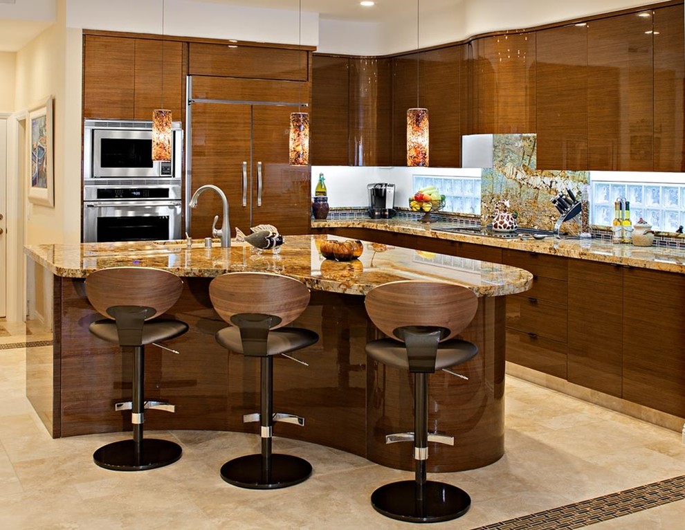 Eat-in kitchen - large eclectic l-shaped limestone floor eat-in kitchen idea in Orange County with an undermount sink, flat-panel cabinets, medium tone wood cabinets, granite countertops, multicolored backsplash, stone slab backsplash, stainless steel appliances and an island
