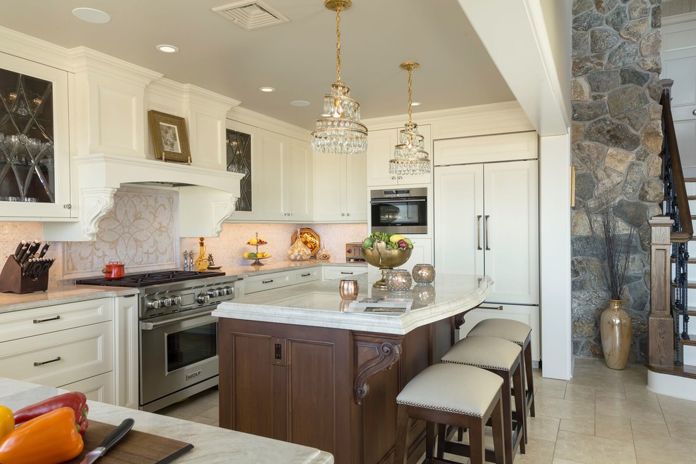 Inspiration for a large timeless u-shaped travertine floor and beige floor open concept kitchen remodel in New York with recessed-panel cabinets, white cabinets, quartzite countertops, white backsplash, an island, white countertops and paneled appliances