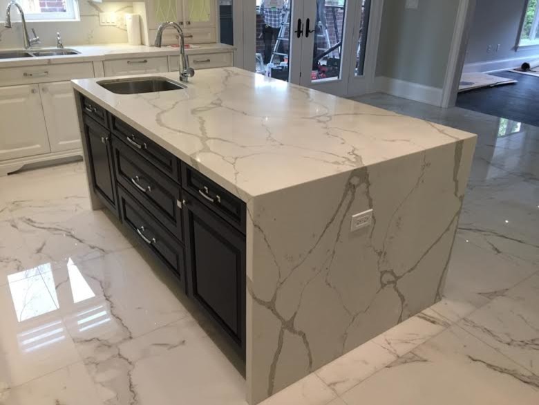Inspiration for a mid-sized transitional l-shaped marble floor open concept kitchen remodel in Toronto with a double-bowl sink, raised-panel cabinets, brown cabinets, marble countertops, white backsplash, stone slab backsplash and an island