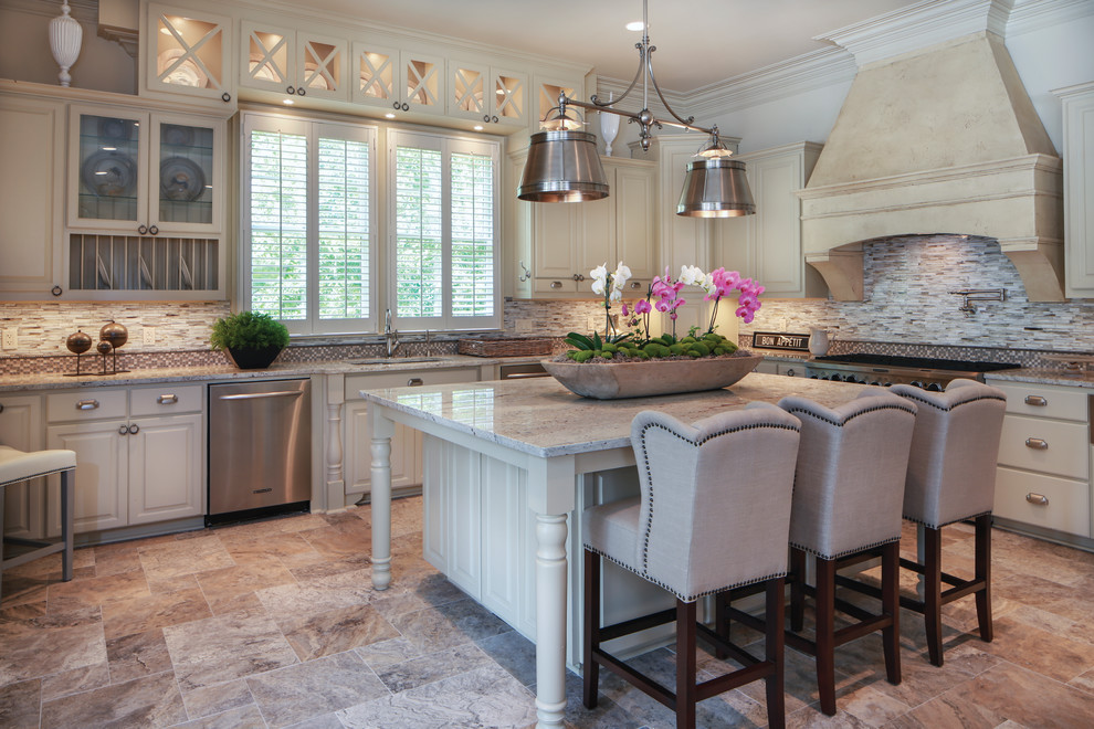 Design ideas for a classic l-shaped kitchen in New Orleans with a submerged sink, glass-front cabinets, white cabinets, granite worktops, mosaic tiled splashback and stainless steel appliances.