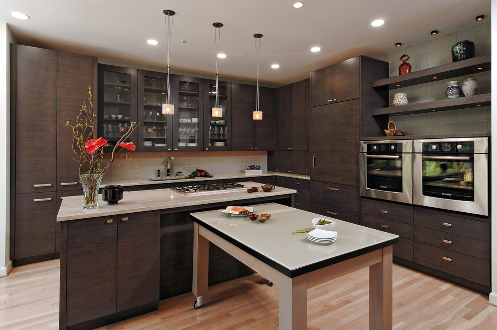 Eat-in kitchen - mid-sized contemporary l-shaped light wood floor eat-in kitchen idea in DC Metro with a drop-in sink, flat-panel cabinets, dark wood cabinets, limestone countertops, white backsplash, subway tile backsplash, stainless steel appliances and two islands