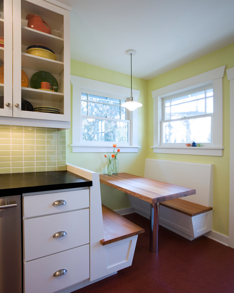 Inspiration for a timeless kitchen remodel in Seattle with glass-front cabinets, wood countertops, white cabinets and green backsplash