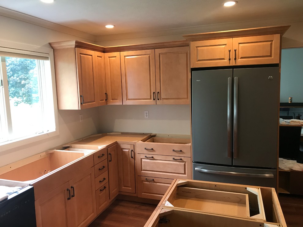 This is an example of a classic kitchen in Other with raised-panel cabinets, orange cabinets, quartz worktops, vinyl flooring, an island and brown floors.