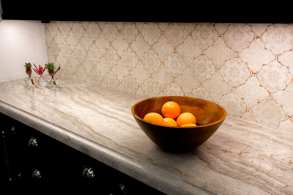 Tuscan kitchen photo in Raleigh with an integrated sink, granite countertops and beige backsplash