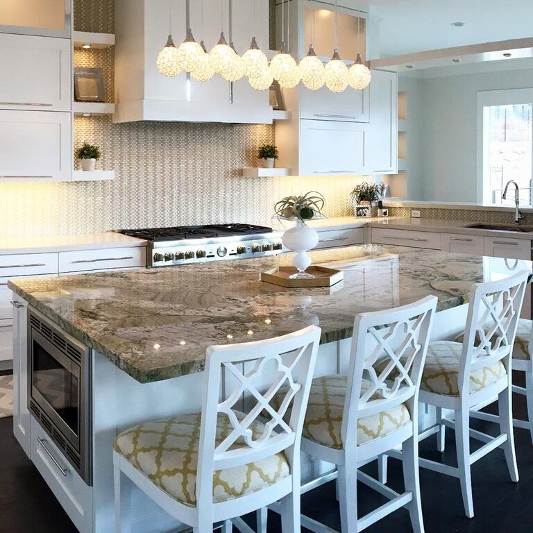 Contemporary u-shaped kitchen/diner in Salt Lake City with a submerged sink, shaker cabinets, white cabinets, granite worktops, white splashback, stainless steel appliances, dark hardwood flooring, an island and black floors.