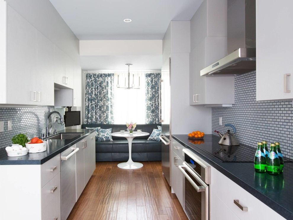 Example of a galley eat-in kitchen design in Los Angeles with an undermount sink, shaker cabinets, gray cabinets, quartz countertops, blue backsplash, ceramic backsplash and stainless steel appliances