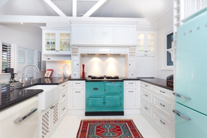 Example of an eclectic u-shaped kitchen design in Sydney with a farmhouse sink, white cabinets, white backsplash and stainless steel appliances